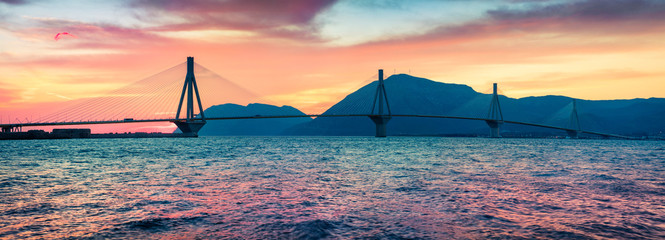 Dramatic evening sunset with Rion-Antirion Bridge. Colorful spring panorama of the Gulf of Corinth,...