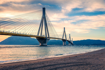 Fototapeta na wymiar Dramatic evening scene with Rion-Antirion Bridge. Colorful spring scene of the Gulf of Corinth, Greece, Europe. Beauty of countryside concept background. Artistic style post processed photo.