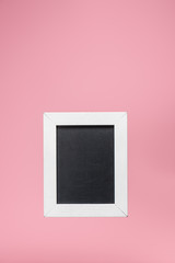 one blackboard in white frame isolated on pink