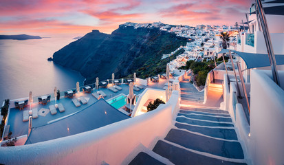 Great evening view of Santorini island. Picturesque spring sunset on the famous Greek resort Fira,...