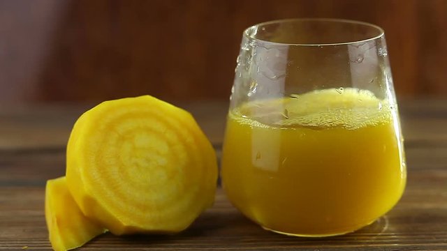 yellow beet juice in glass on  table