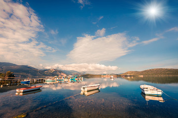 Sunny spring scene in the small fishing town - Mikrovivos. Splendid morning seascape of Aegean sea....