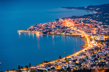 Fototapeta premium View from the bird's-eye of Kamena Vourla town in the evening light. Colorful spring cityscape in Greece, Europe. Beautiful sunset on Aegean Sea. Artistic style post processed photo.