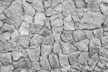 Grey stone wall texture. Ancient natural cobblestone road as background.