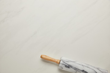 top view of rolling pin on white marble surface