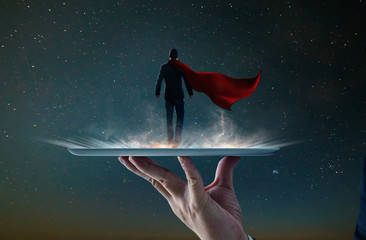 Waiter hand holding an empty digital tablet with Businessman in a suit and cape hero ,victory...