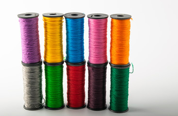 multicolored threads, scissors and ruler, basket. on a light background