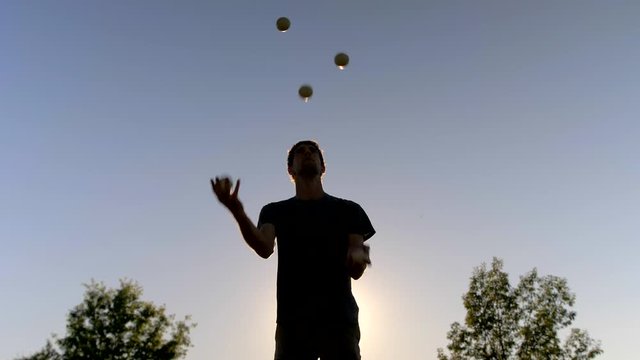 Man Juggling Five Balls at Sunset, Silhouette