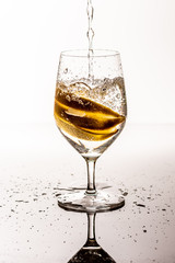 Glass with a drink with lemons and some splashes