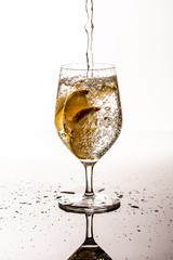 Glass with a drink with lemons and some splashes