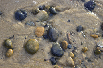 Fototapeta na wymiar Stone in beach sand
