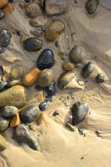 Fototapeta na wymiar Stone in beach sand