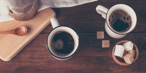Obraz na płótnie Canvas two coffee mugs and sugar, top view, long banner