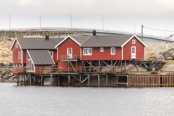 norwegian old city with reflections in water and cloudy sky, norway, europe, lofots, lofoten, rorbuer