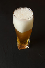 Light beer in a glass bowl on a black background. Beer in the bar