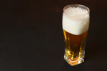 Light beer in a glass bowl on a black background. Beer in the bar