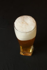 Light beer in a glass bowl on a black background. Beer in the bar