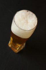 Light beer in a glass bowl on a black background. Beer in the bar
