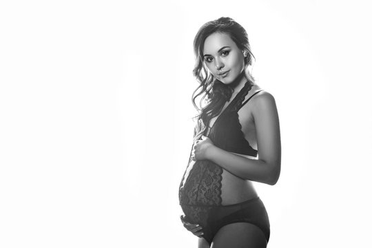 pregnant woman on white background black and white photo