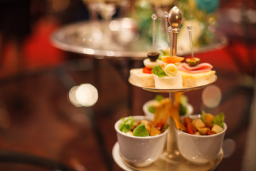 Canapes Assortment on silver tray on table background. Hotel venue restaurant food catering service buffet, cocktail banquet for wedding ceremonies, seminars, meetings, conferences, parties or events
