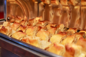hotel restaurant food catering service buffet banquet for wedding ceremonies, seminars, meetings, conferences, parties or events. Freshly baked pork sausage stuffed puffs pastry in warm chafing dish
