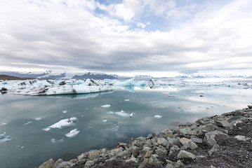 Jökulsárlón glacier lagoon with refelctions of a ice rock in the water an the glacier in the background of the jökulsarlon