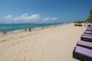 white sand beach with people in Nusadua Bali Indonesia