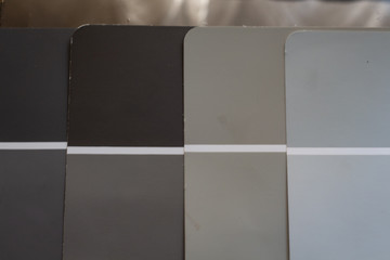 Paint chip samples for redecorating interior or exterior. Deciding on colors. Neutral beige and gray