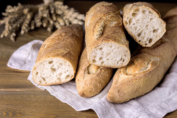 Naklejka premium Tasty Crusty Baguettes on Wooden Background Tasty Homemade Bread Horizontal Above