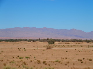 Fototapeta na wymiar Panorama of sandy desert at high ATLAS MOUNTAINS range landscape in MOROCCO