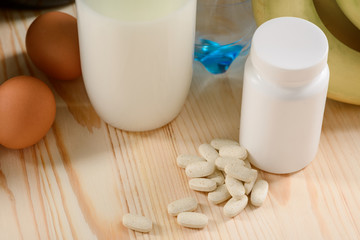 Scattered vitamins near the can