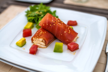rolls of tuna with crab meat on the plate