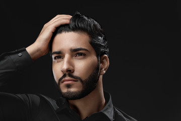 Men Hair Care. Man With Beard, Beauty Face Touching Black Hair