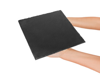 woman hand holding empty square slate platter. perspective view Template for your design. isolated on white background