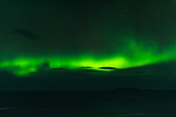 norwegian aurora borealis with mountains and water, view from hurtigruten ship boat, norway, europe, green northern lights