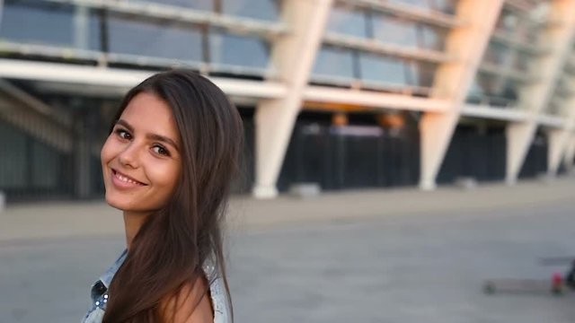 Young stylish woman looking at camera and doing bye bye gesture.