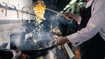 Chef stirring cooking