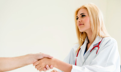 Woman Doctor and Male Patient in Hospital Office