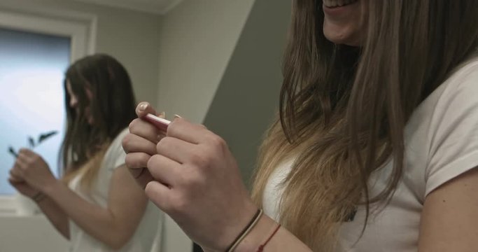 Happy woman with pregnant test