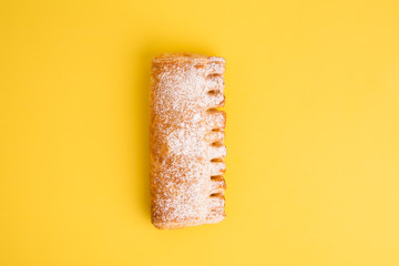cream cane cake, with sugar on yellow background