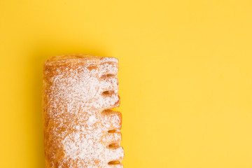 cream cane cake, with sugar on yellow background