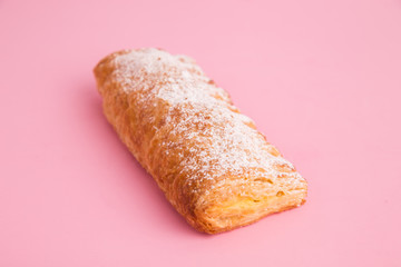 cream cane cake, with sugar on pink background