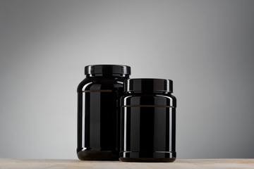 Two black cans with protein