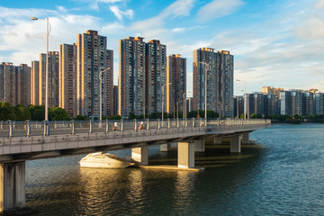 Obraz premium Daytime Upscale Apartments on River and Boating Area