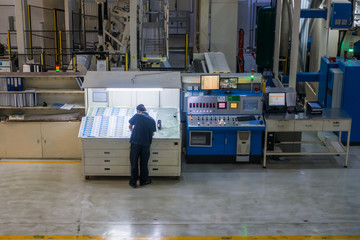 Employee Working at Printing Equipment Factory Industrial Setting