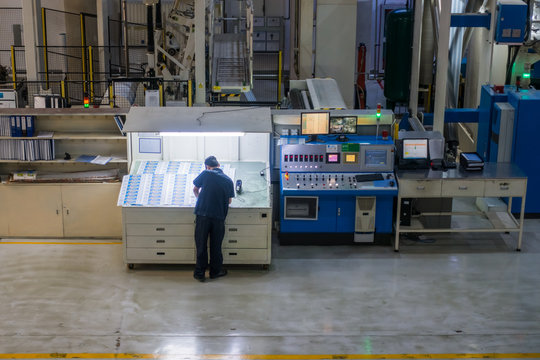 Employee Working at Printing Equipment Factory Industrial Setting