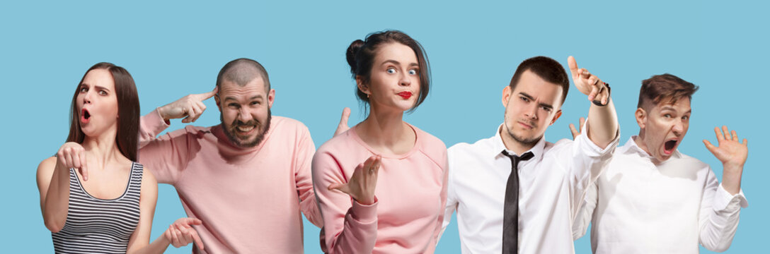 Argue, arguing concept. Beautiful male and female half-length portrait isolated on blue studio backgroud. Young emotional surprised men and woman looking at camera. Human emotions, facial expression