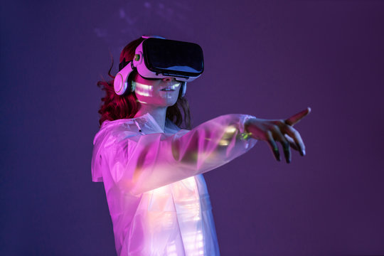 Woman touching air in VR glasses