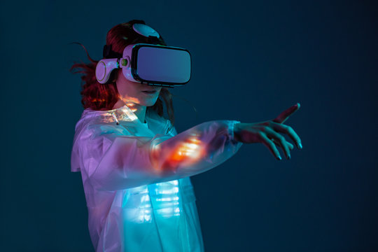 Woman touching air in VR glasses