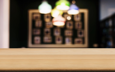Empty wooden table and blurred background of abstract in front of coffee shop or restaurant for display of product or for montage